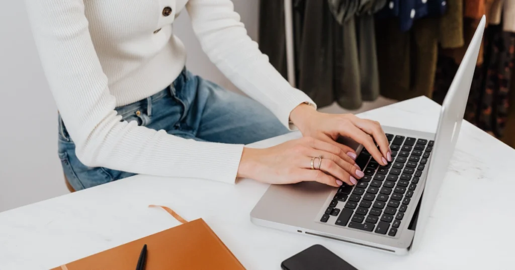 E-commerce brand owner managing email marketing strategy on a laptop