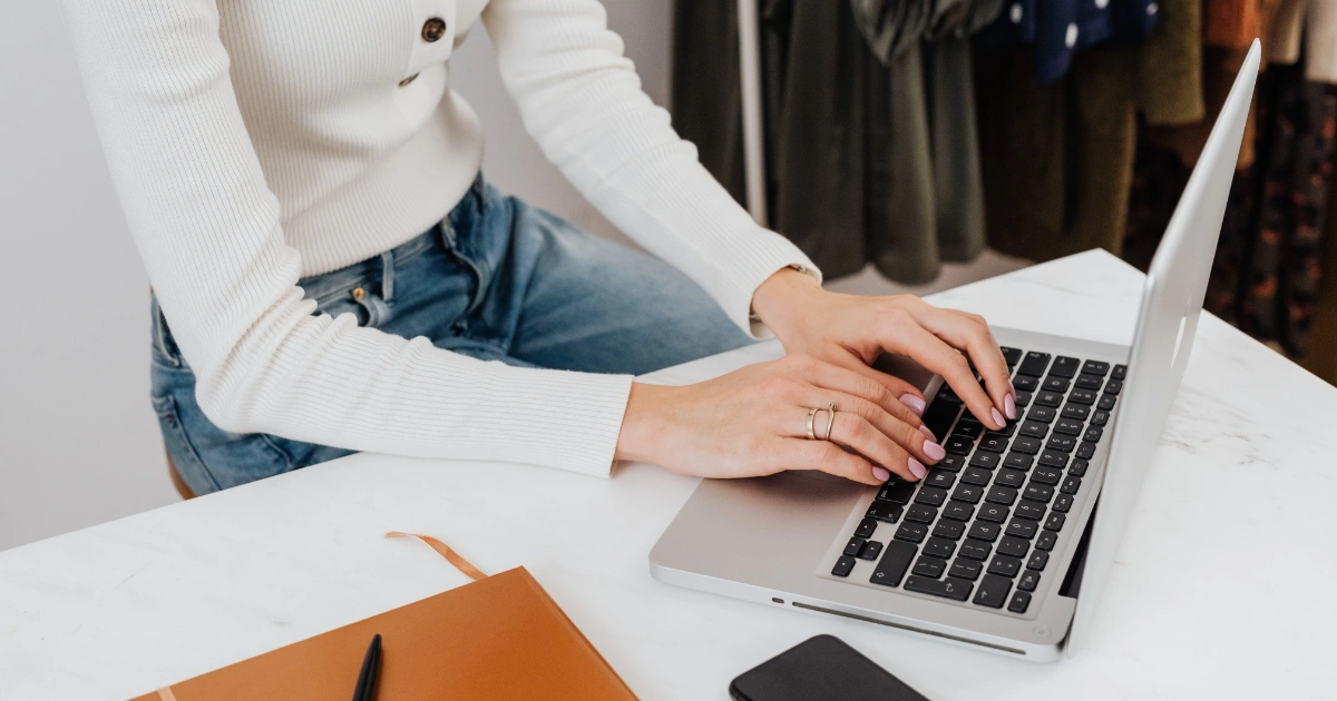 E-commerce brand owner managing email marketing strategy on a laptop